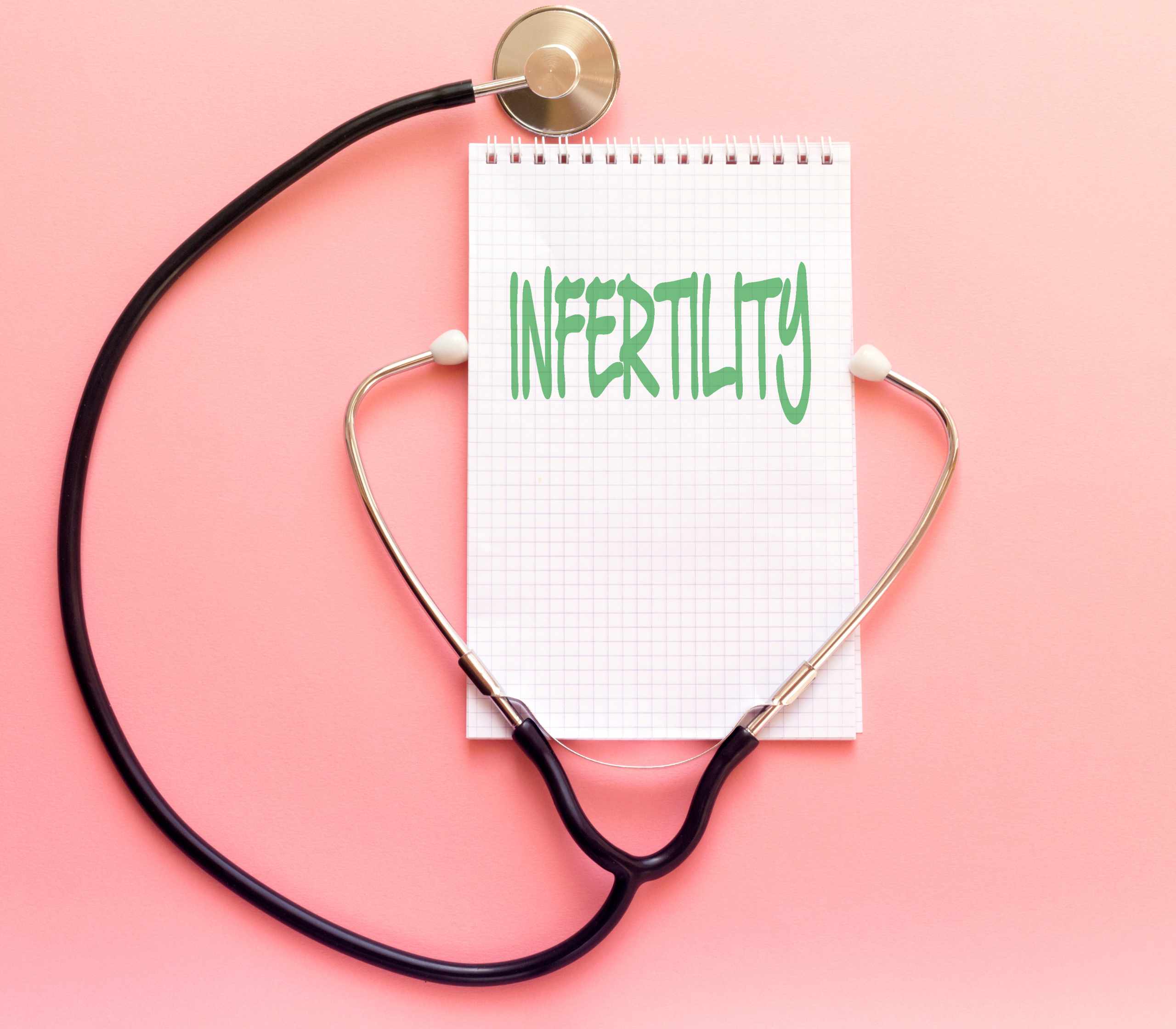 Pink background with a stethoscope on top of a note pad that says infertility. how do you know if you're facing infertility