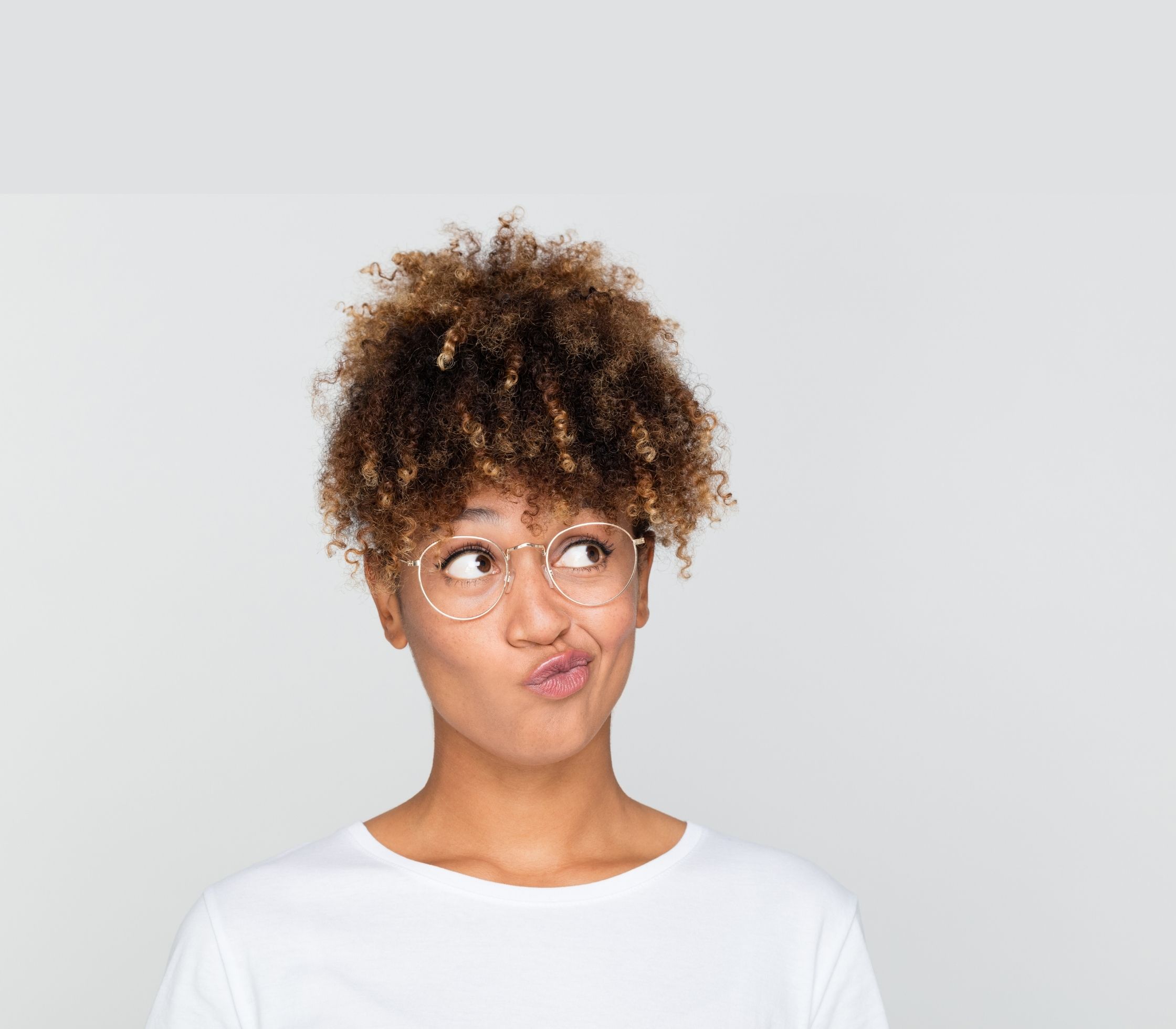 An African American woman pondering which represents how to choose an egg donor.