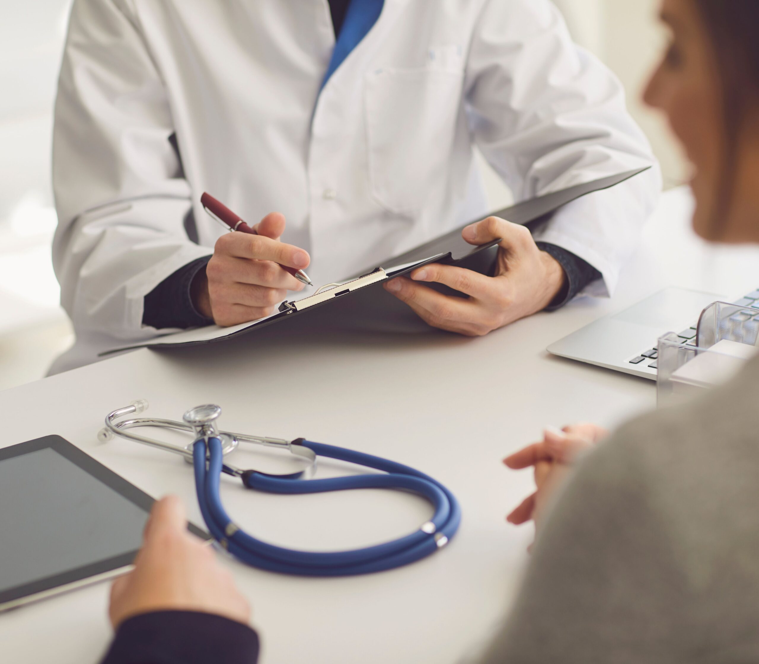 Doctor in whit lab coat holding a clip board representing How much do egg donors make