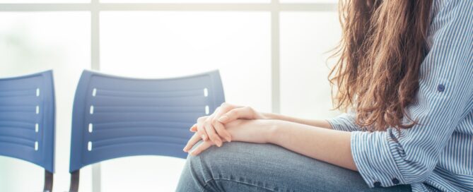 Young woman sitting in a waiting room.