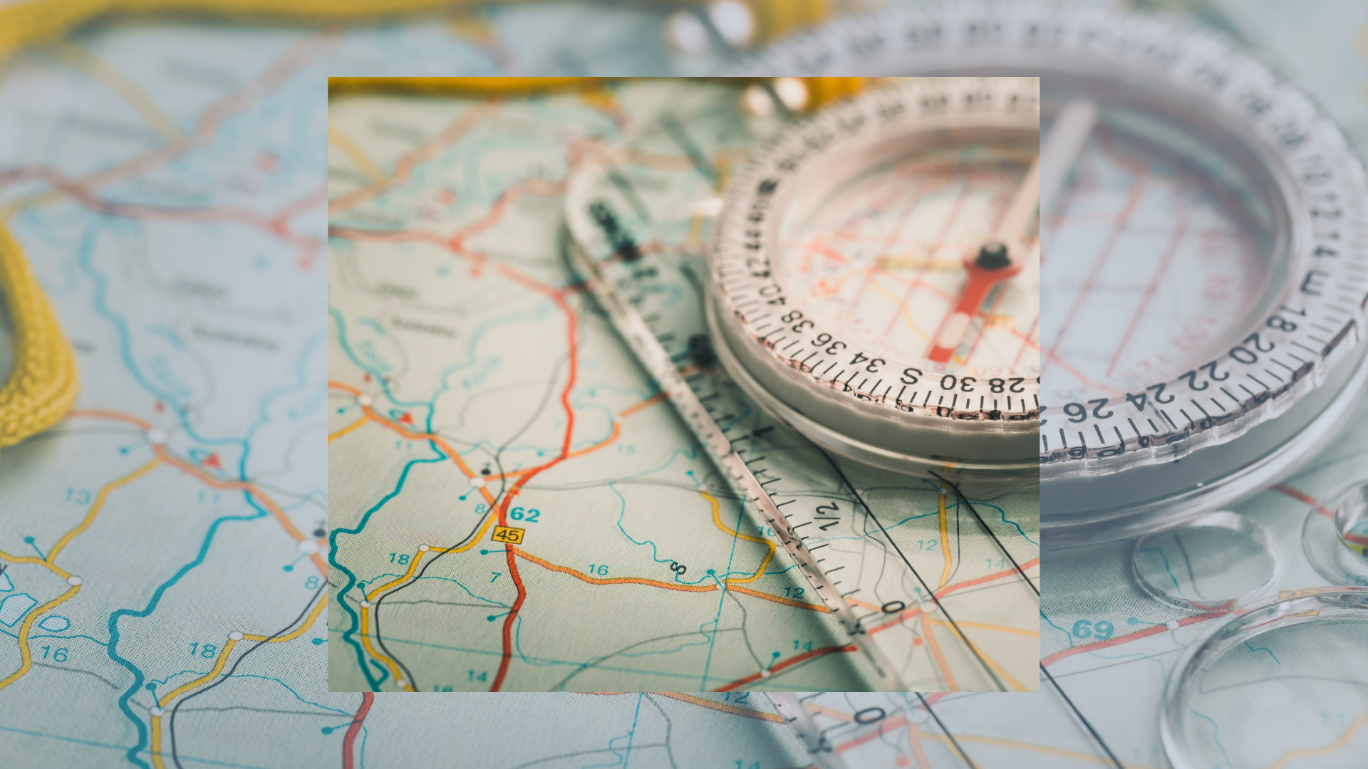 I image of a compass laying on top of a detailed map of the United States.